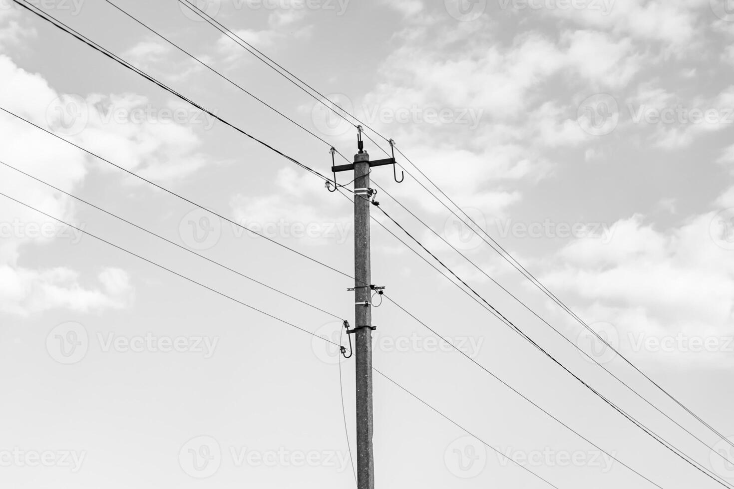 Power electric pole with line wire on dark background close up photo