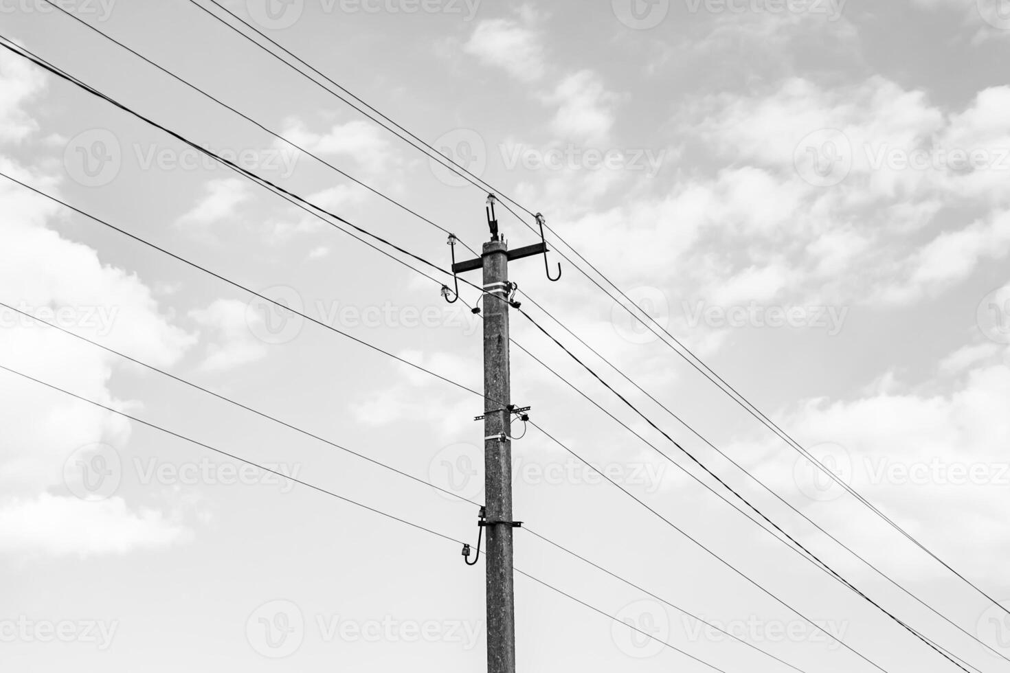 Power electric pole with line wire on dark background close up photo