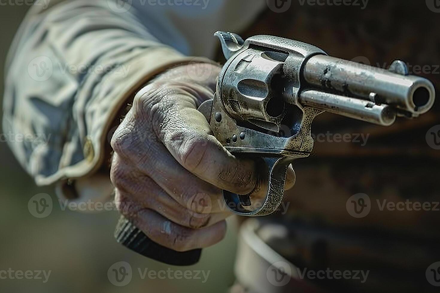 Man aims through the sight of combat metal pistol to hit the target photo