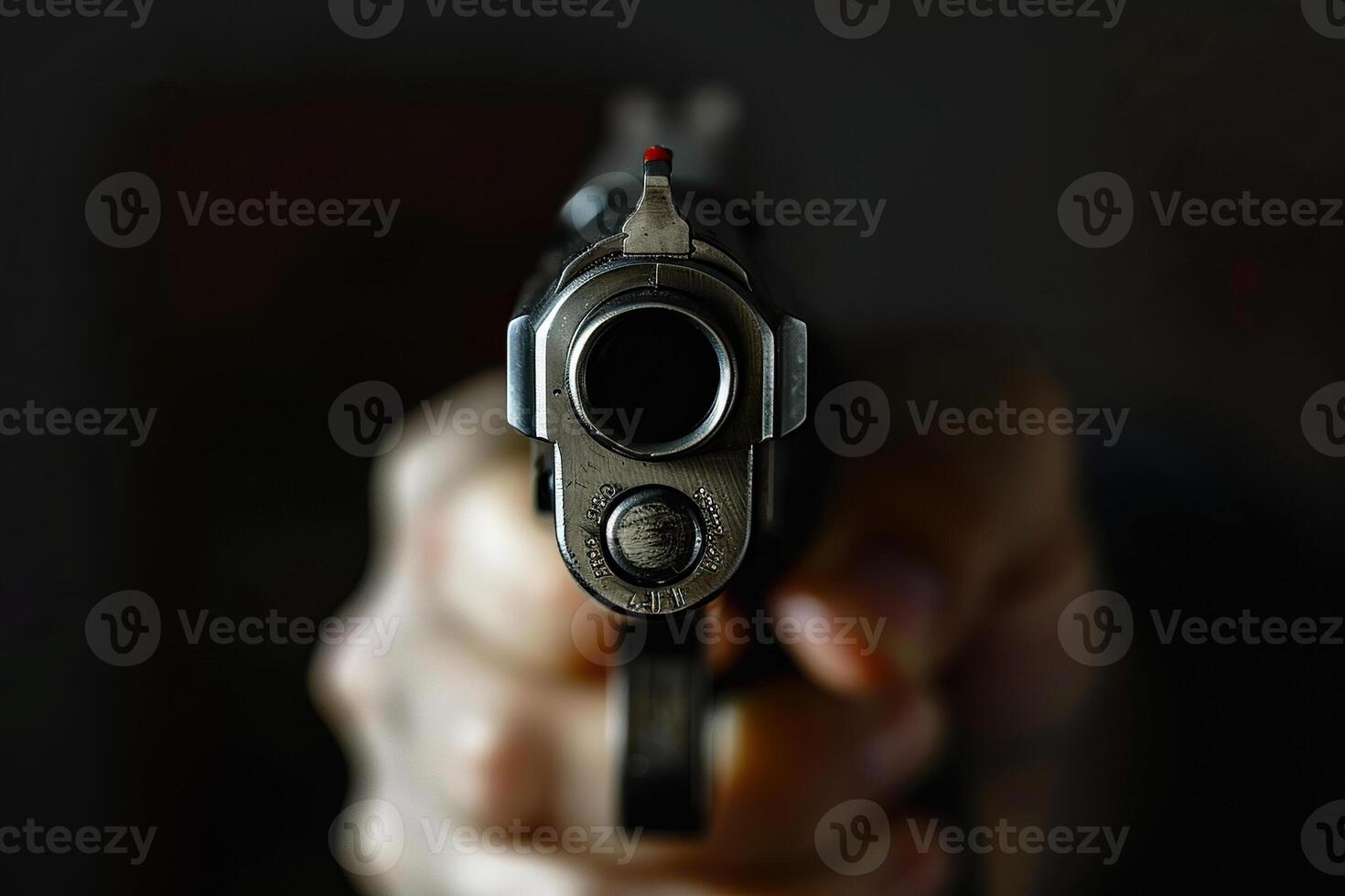 Man aims through the sight of combat metal pistol to hit the target photo