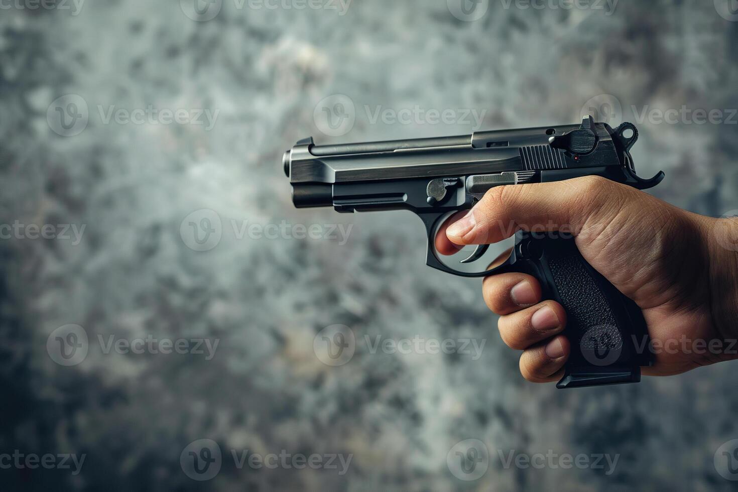 Man aims through the sight of combat metal pistol to hit the target photo