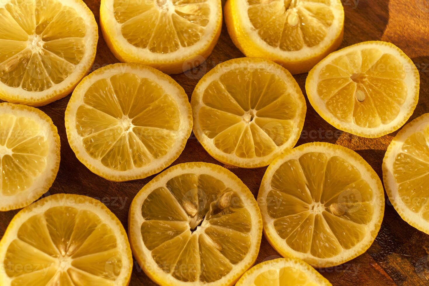 Slices of organic lemon on a wooden cutting board photo