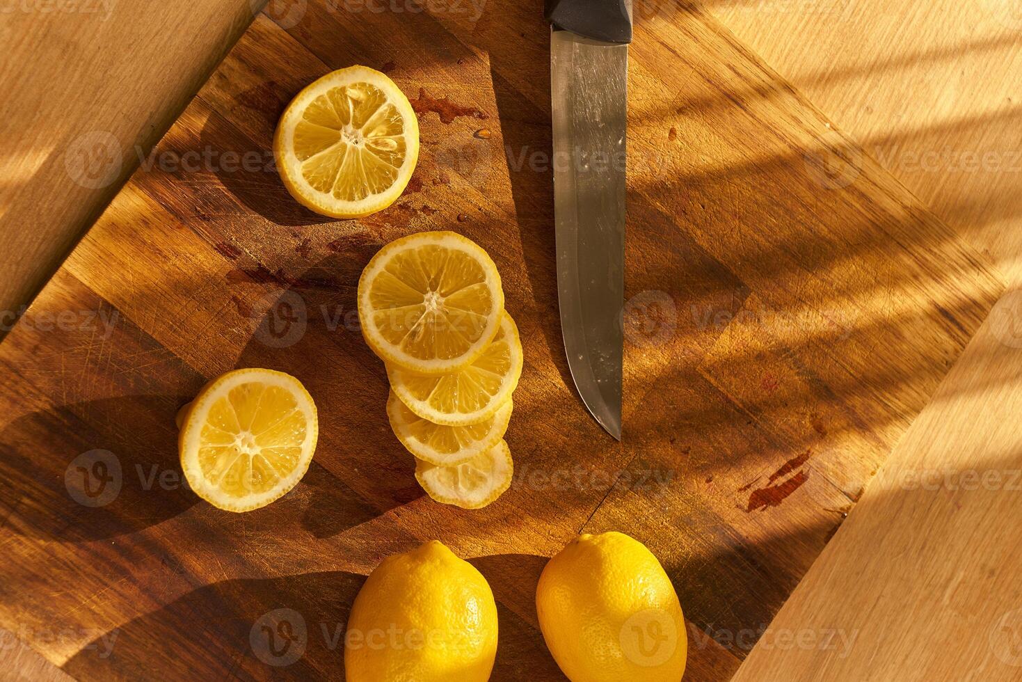 Slices of organic lemon on a wooden cutting board photo