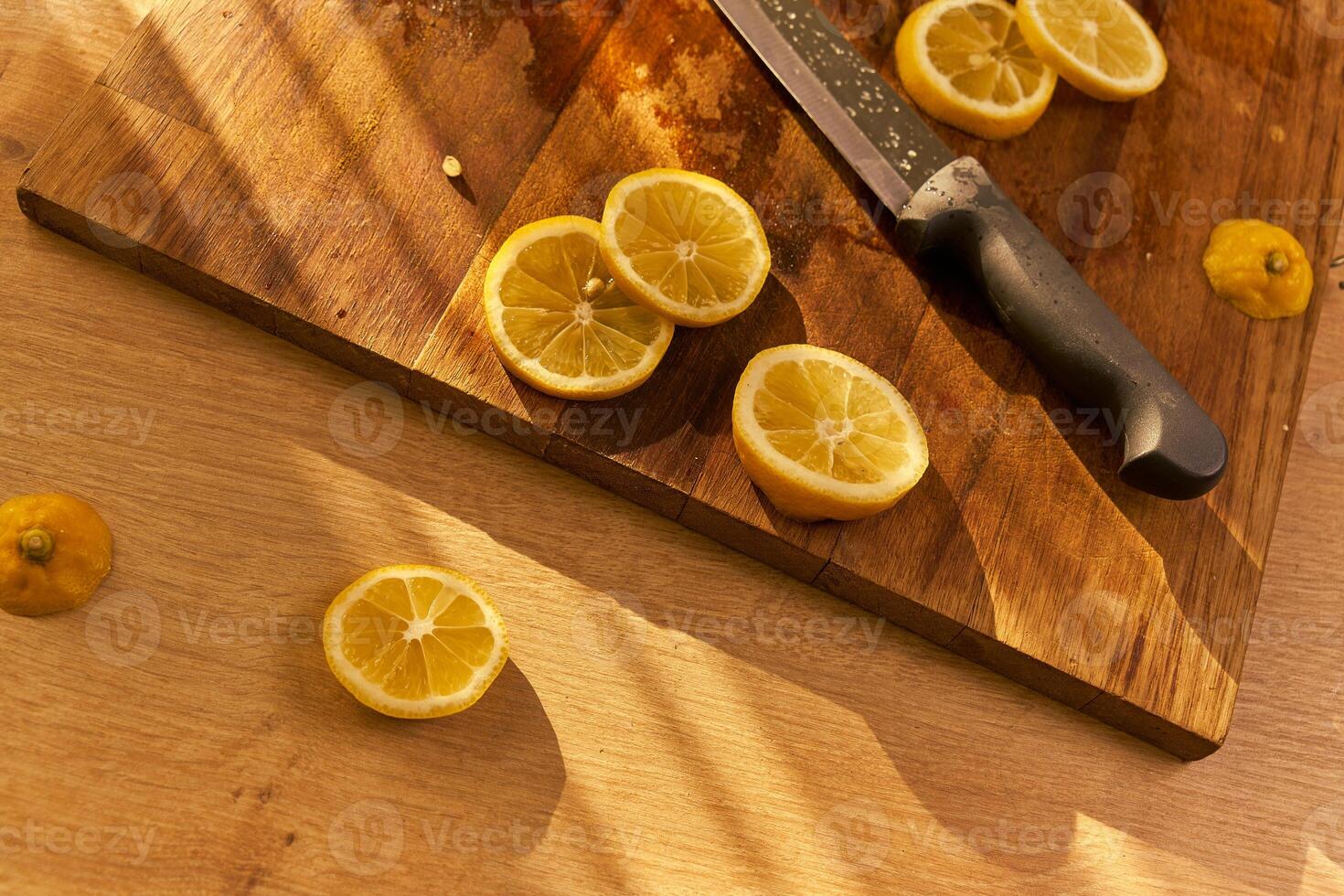Slices of organic lemon on a wooden cutting board photo