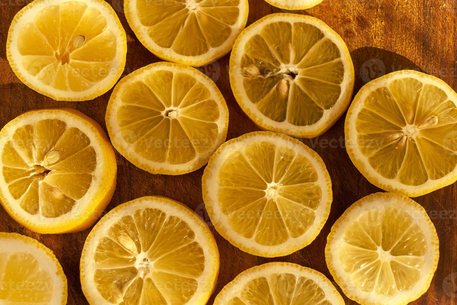 Slices of organic lemon on a wooden cutting board photo