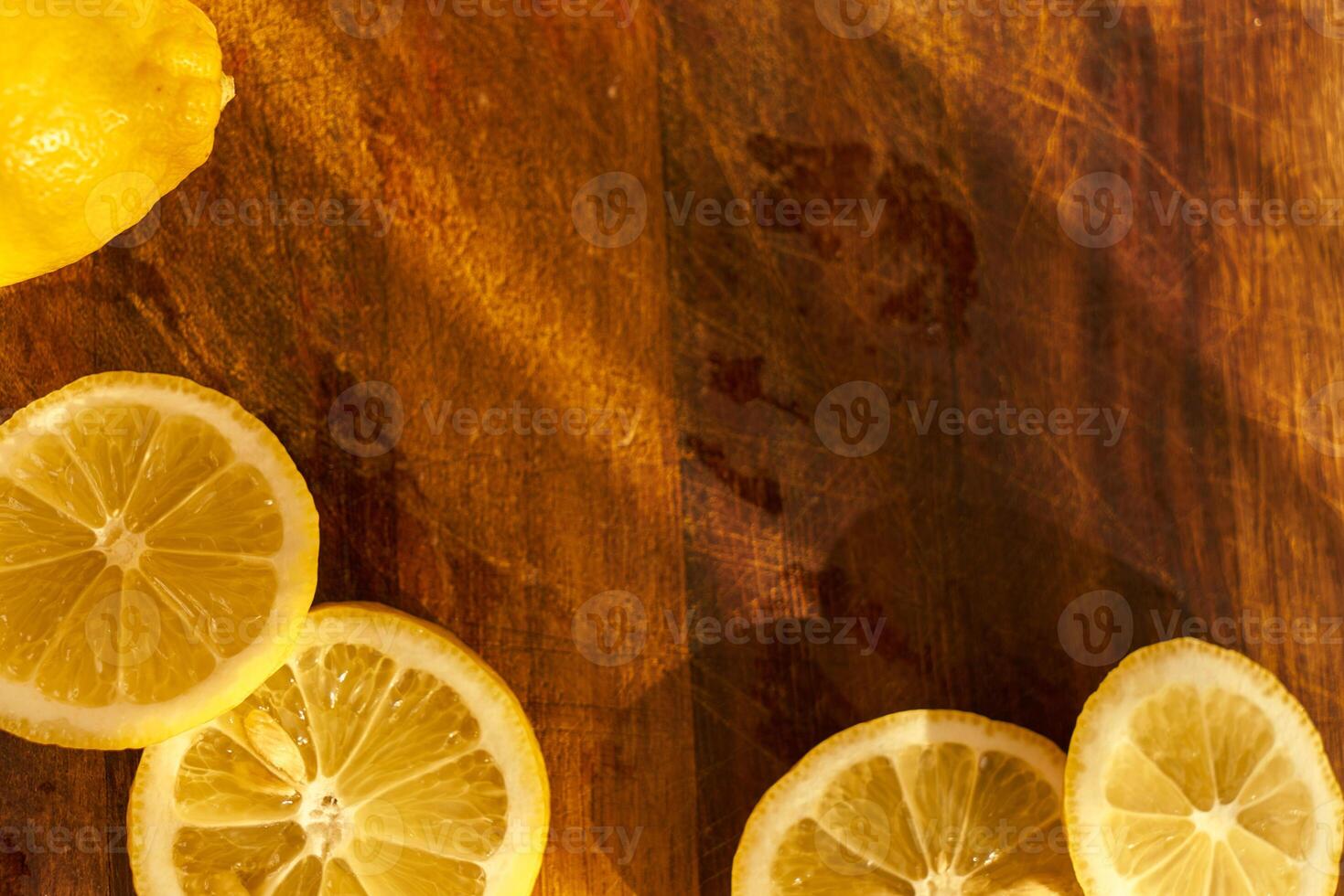 Slices of organic lemon on a wooden cutting board photo