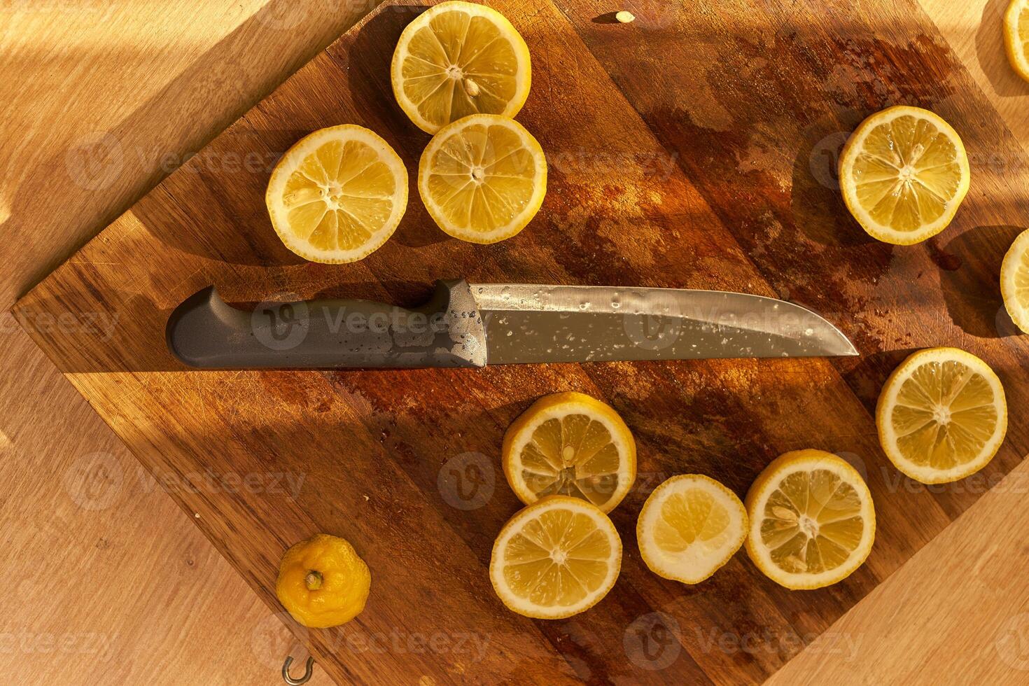 Slices of organic lemon on a wooden cutting board photo