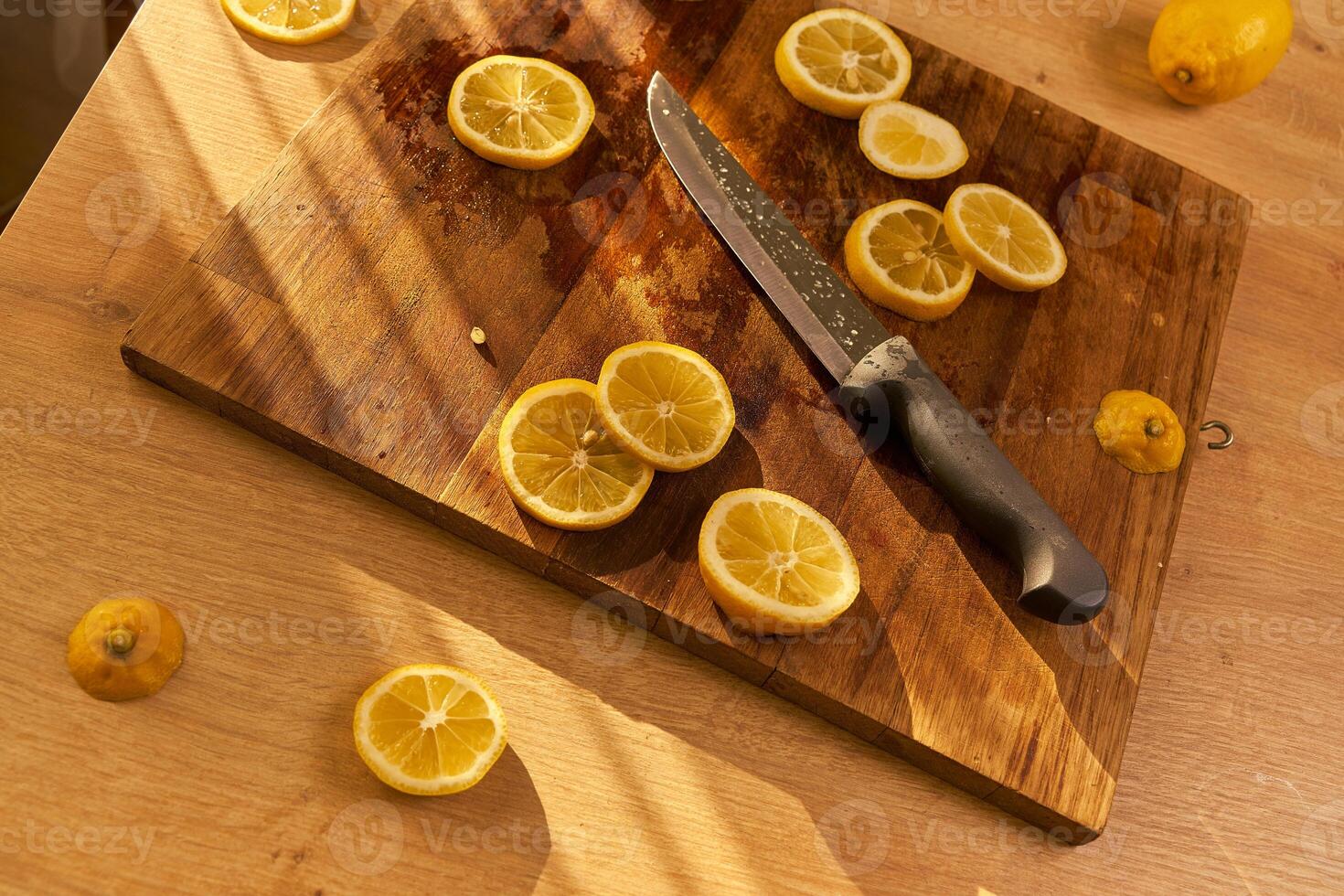 Slices of organic lemon on a wooden cutting board photo