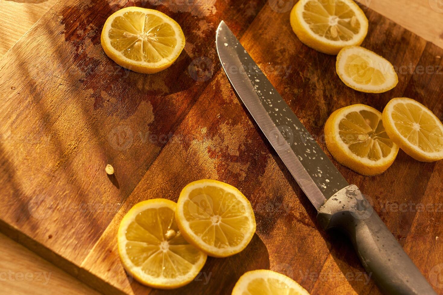 Slices of organic lemon on a wooden cutting board photo