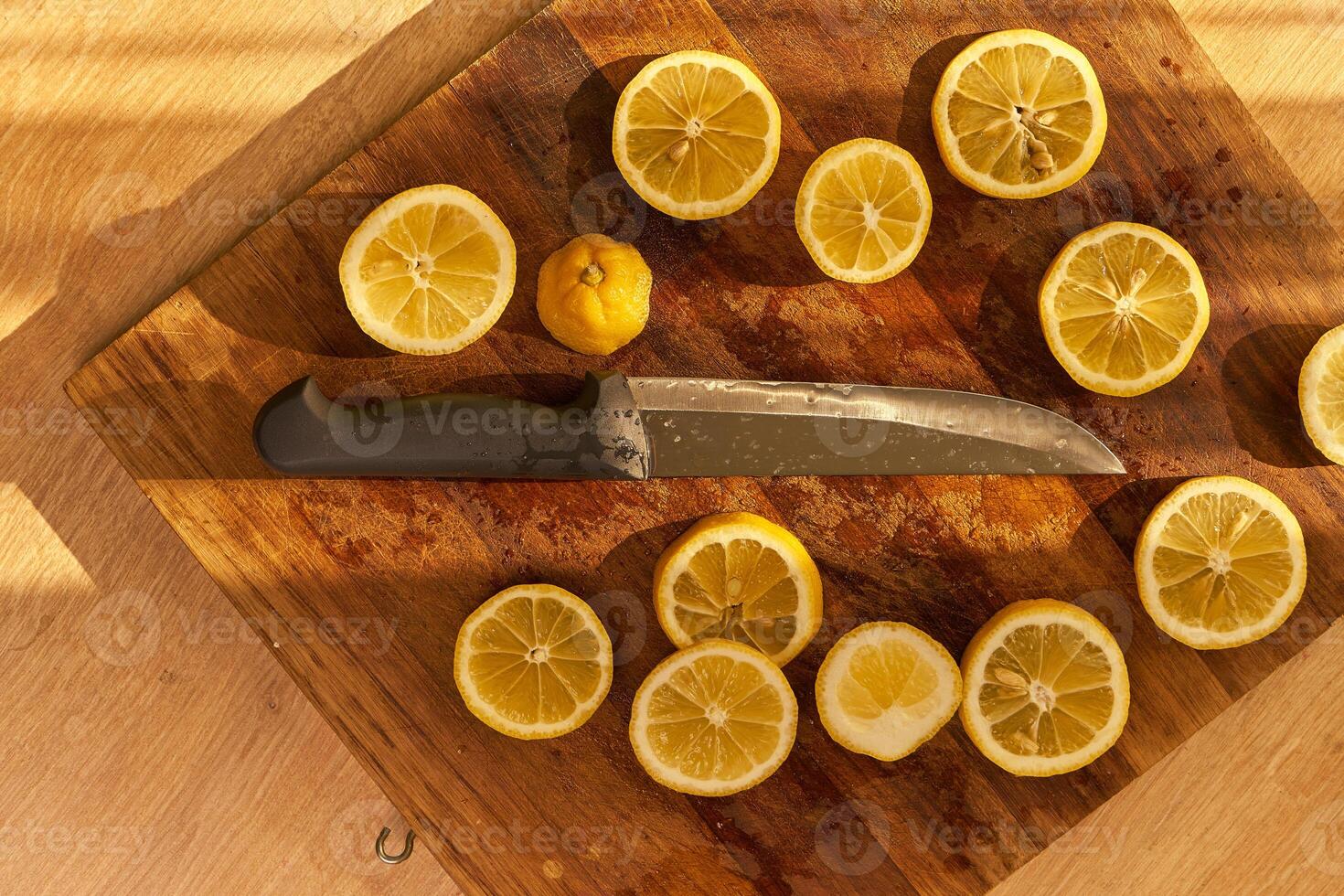 Slices of organic lemon on a wooden cutting board photo