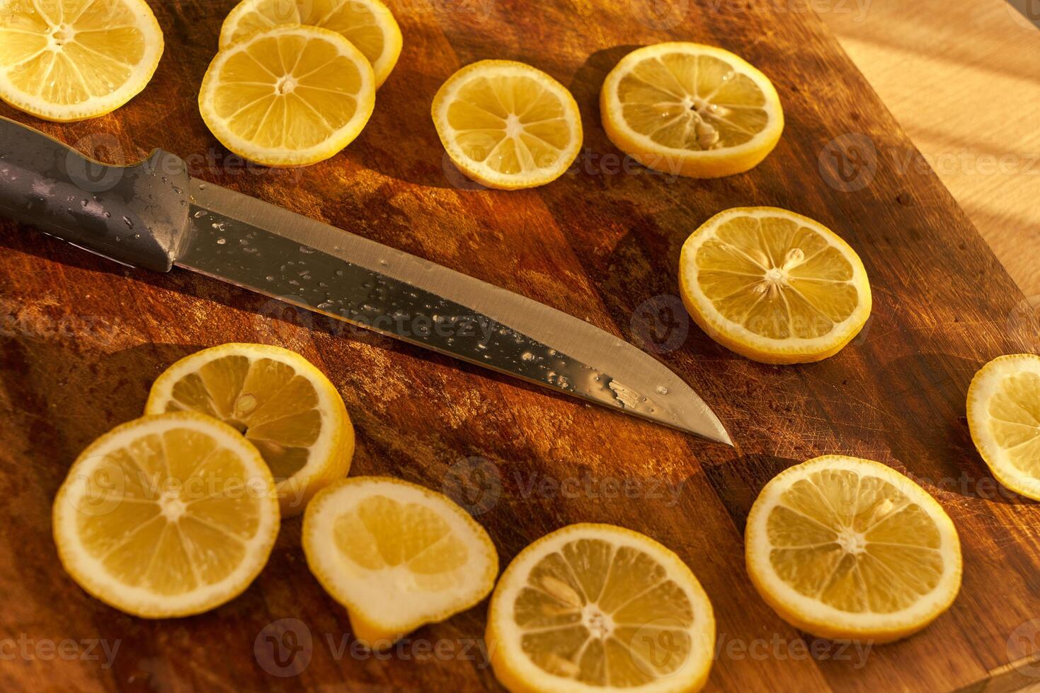 Slices of organic lemon on a wooden cutting board photo