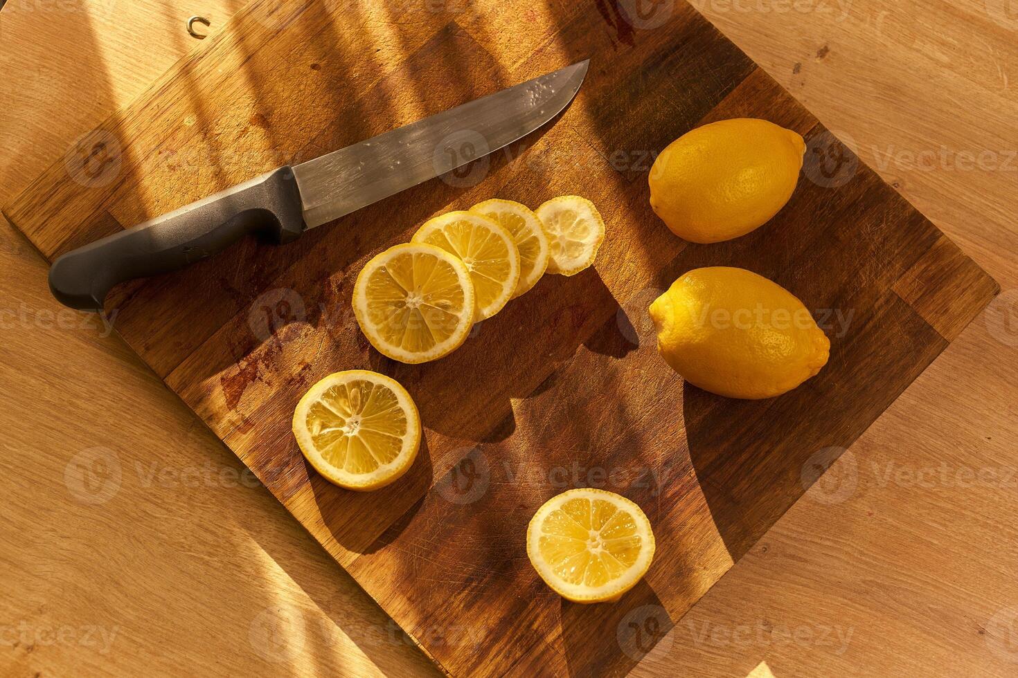 Slices of organic lemon on a wooden cutting board photo