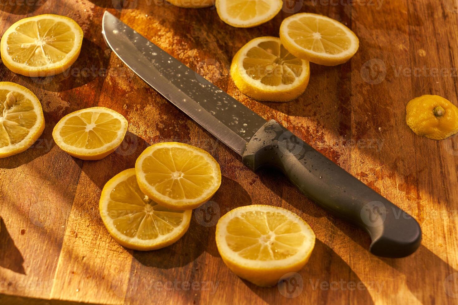 Slices of organic lemon on a wooden cutting board photo
