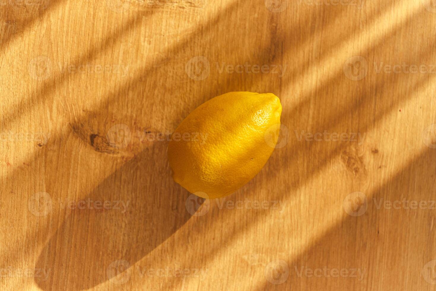 Slices of organic lemon on a wooden cutting board photo
