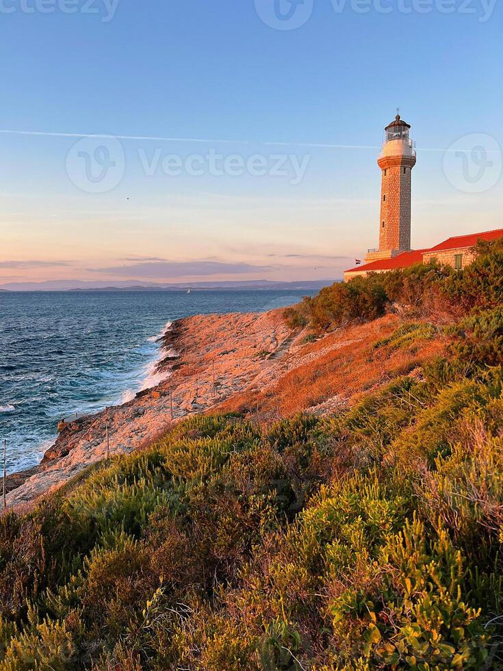 Lighthouse Stoncica at sunset light on island Vis, Croatia. photo
