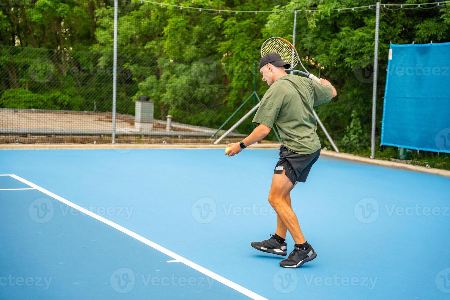 Professional male tennis player playing the tennis on outside court. High quality photo