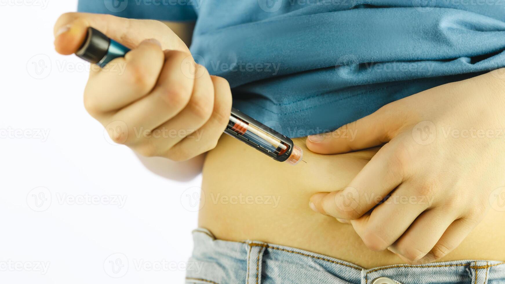 Boy with diabetes makes an insulin injection into the belly photo