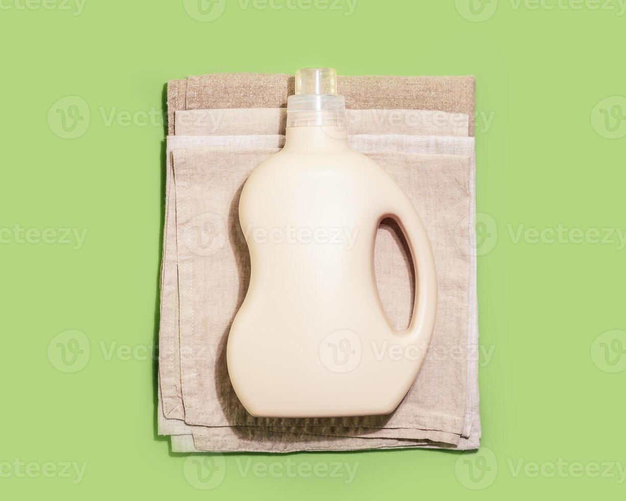 Bottle with washing gel or fabric softener on a textile napkins photo