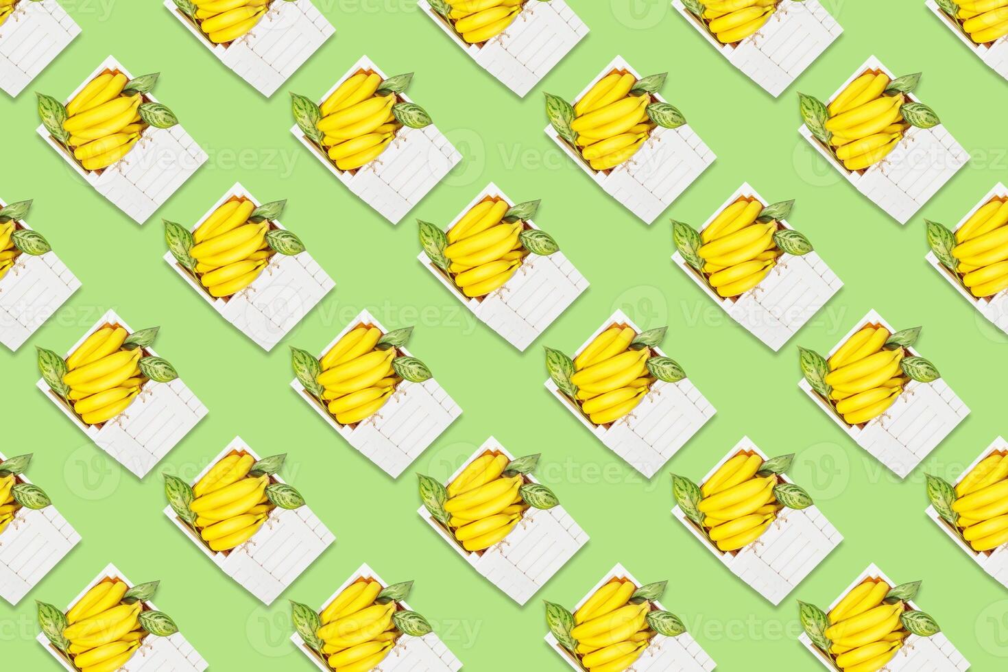 Summer seamless pattern with bananas on green background photo