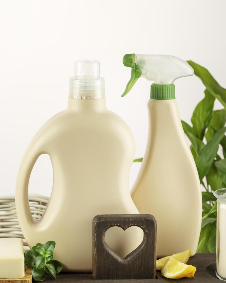 Detergent bottles, soap and lemon slices on wooden shelf photo