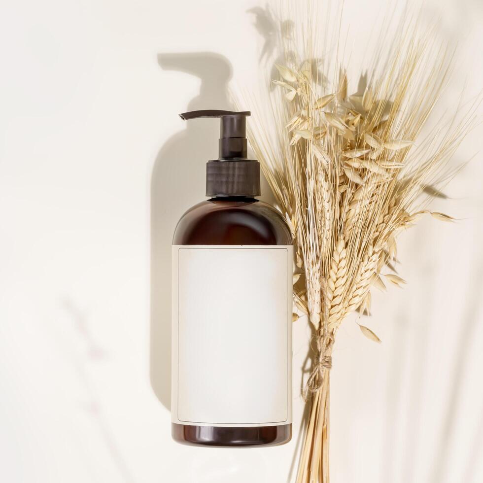 Dispenser bottle with natural beauty product on a light background photo
