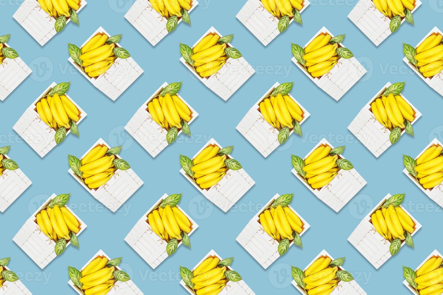 Summer seamless pattern with bananas in white wooden box photo