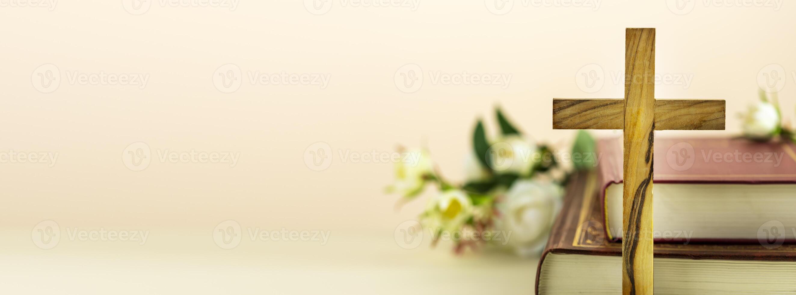 Religion banner with wooden cross and Christian bibles and copy space photo