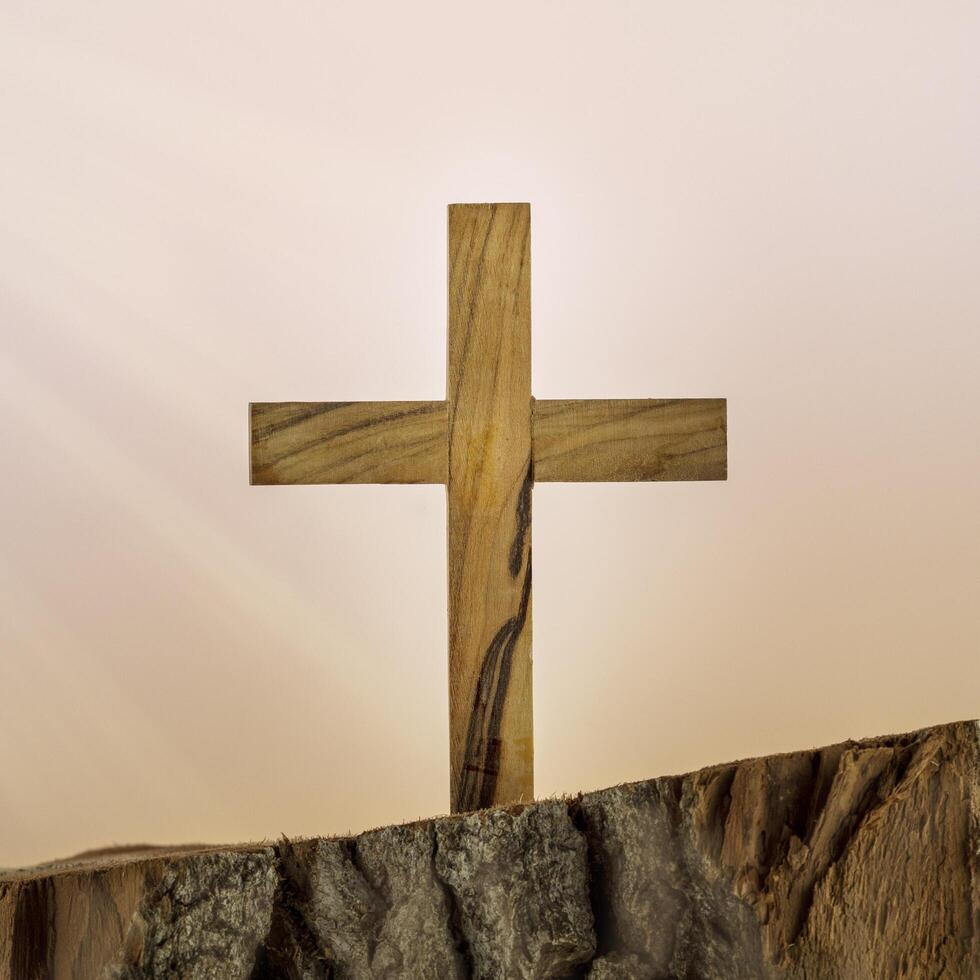Christian wooden cross on a gradient background photo