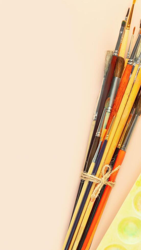 Art school flat lay with brushes and palette with copy space photo