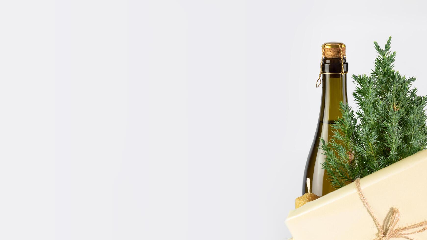 Small Christmas tree, bottle of champaign and gift with copy space photo