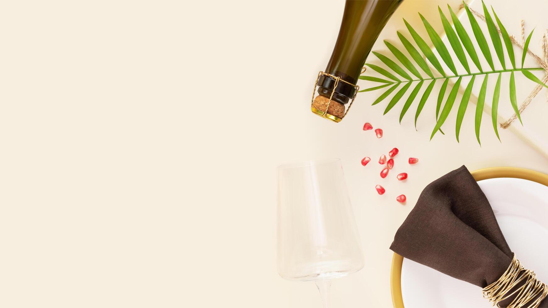 Holiday background with present, table settings and bottle of champagne photo