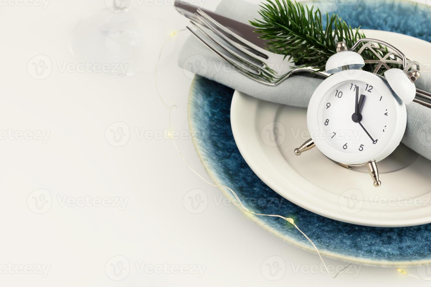 Christmas and New year table setting with clock and holiday decor photo
