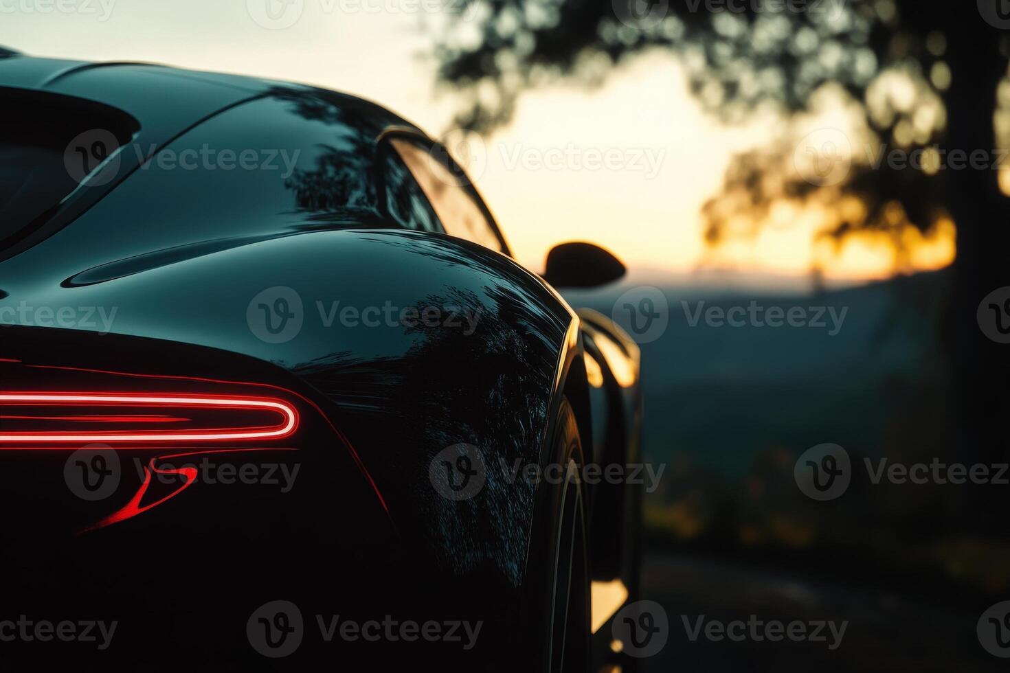 The elegant curves of a luxury cars rear are highlighted by the glowing tail light against a breathtaking sunset backdrop. photo