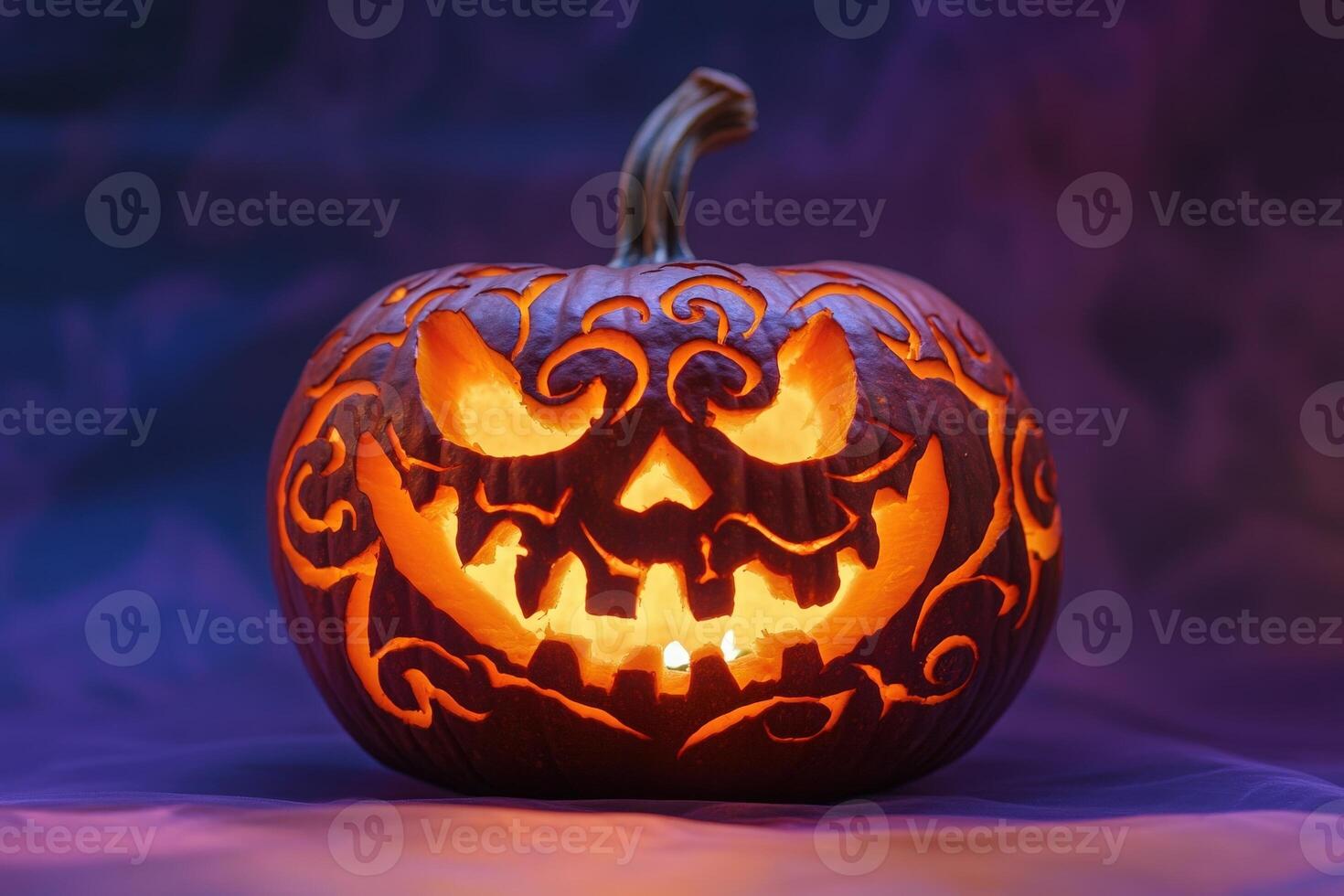 A stunning carved pumpkin illuminates the dark with its eerie grin and intricate designs, capturing the essence of Halloween festivities. photo