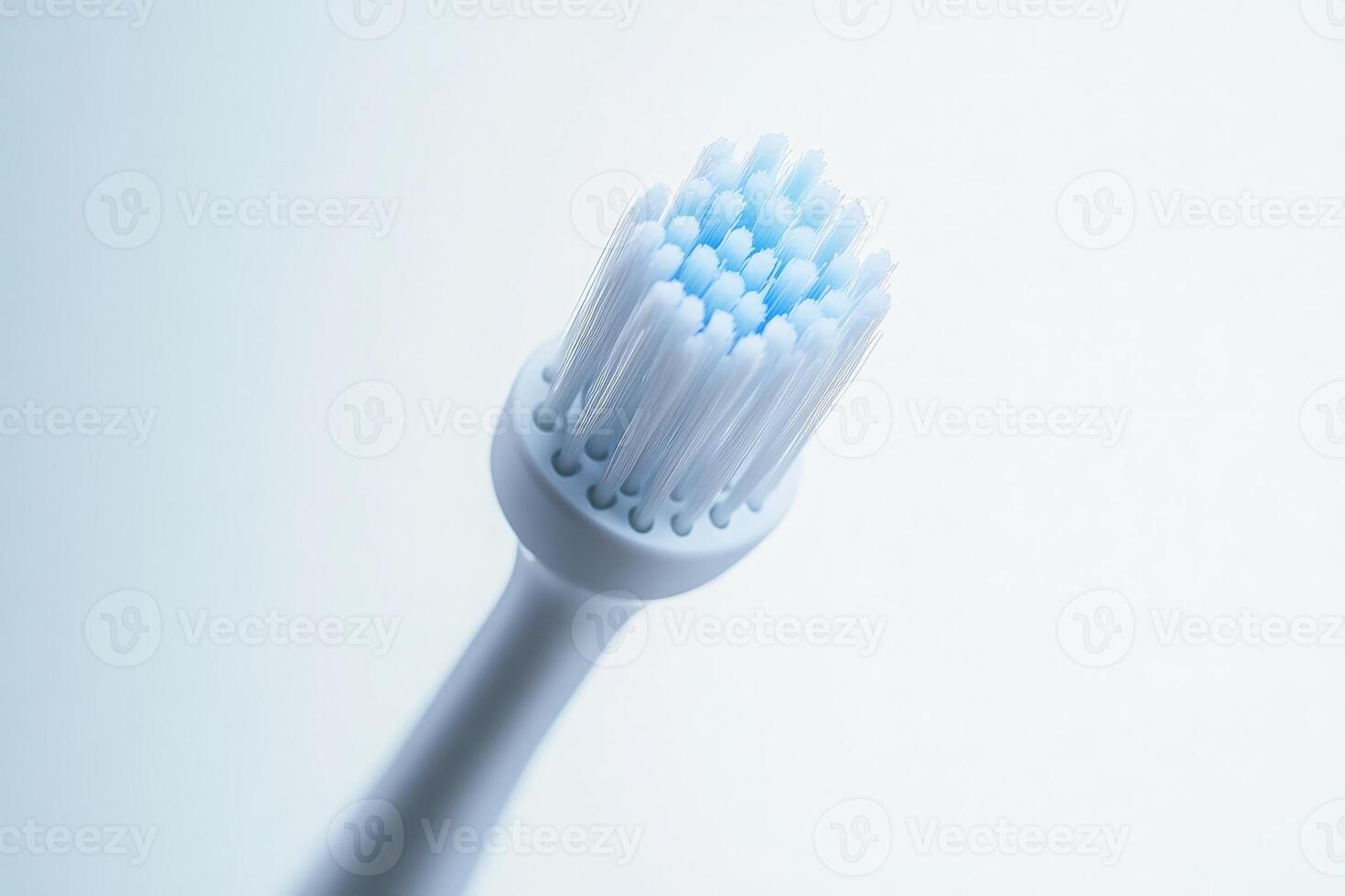 A sleek electric toothbrush stands isolated, emphasizing its modern design and advanced features in a soft, minimalist setting. photo