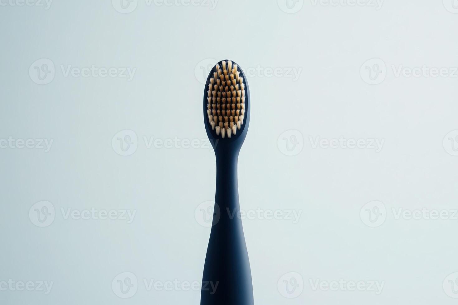 A stylish electric toothbrush stands out with its sleek design against a smooth, light-hued backdrop, embodying modern dental care. photo