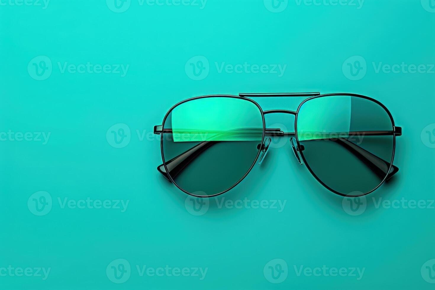 A pair of chic sunglasses sits elegantly on a bright turquoise background, reflecting a playful ambiance and inviting attention. photo