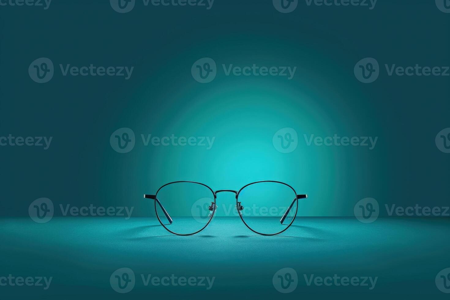 An isolated pair of sleek, modern glasses rests on a smooth surface, elegantly highlighted by a teal glow that enhances their design. photo