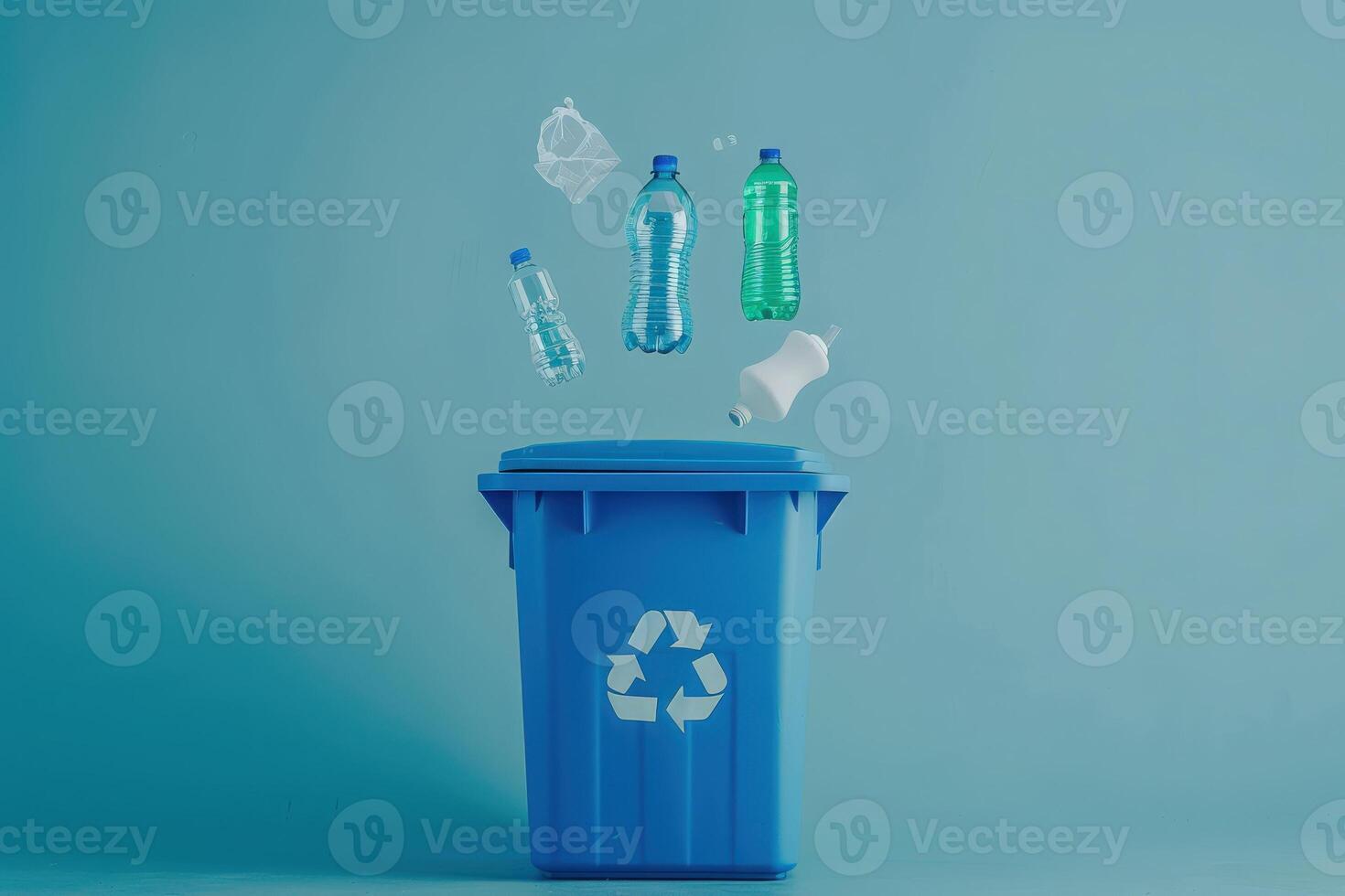 Colorful bottles hover above a recycling bin, creating an artistic display that emphasizes the importance of recycling and sustainability. photo