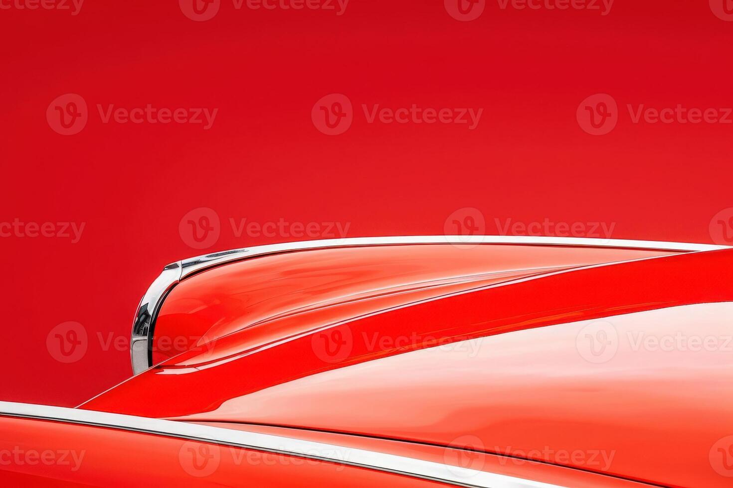 A slightly crumpled fender shines with striking curves and chrome details, set against a bold red background that enhances its classic beauty. photo