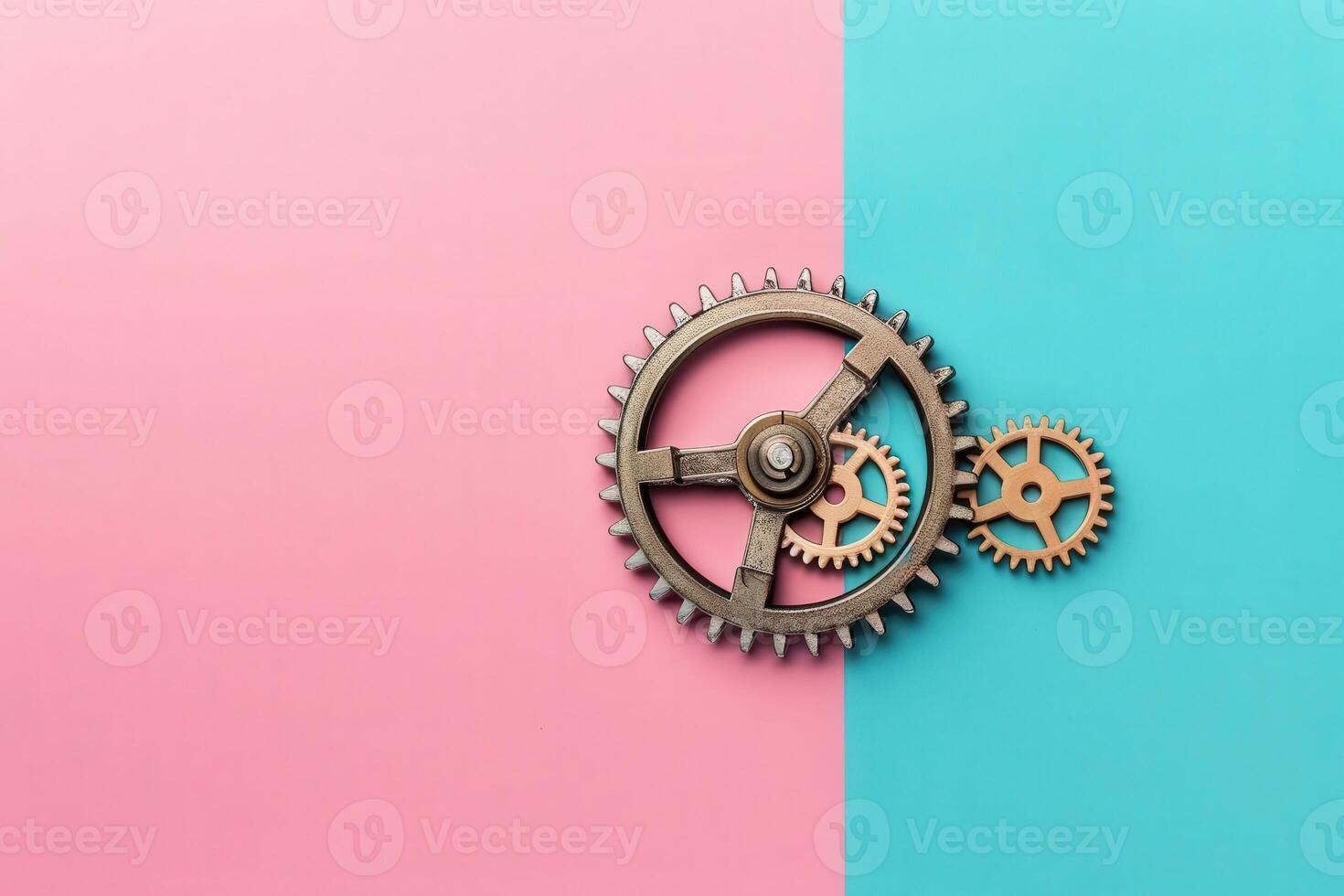 A set of metallic gears rests elegantly on a split pink and blue backdrop, representing the concept of automation and efficiency in modern business. photo