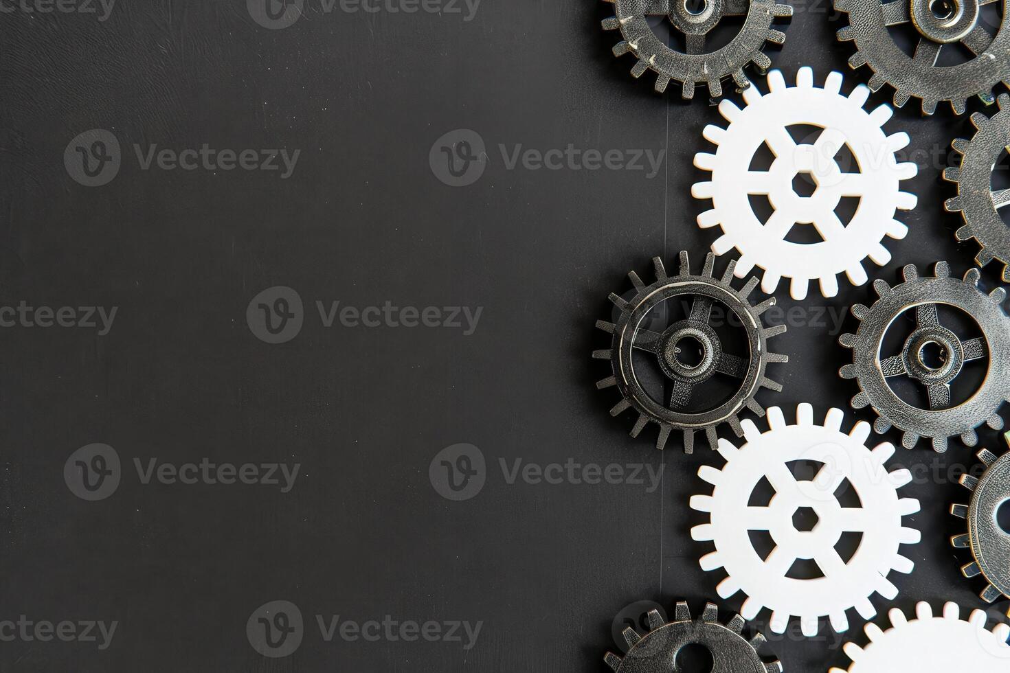 An arrangement of black and white gears on a solid black background highlights the theme of business process automation. photo