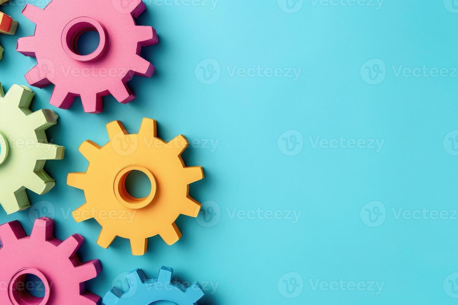 Vibrantly colored gears are creatively displayed on a smooth blue surface, representing the concept of automation and productivity. photo