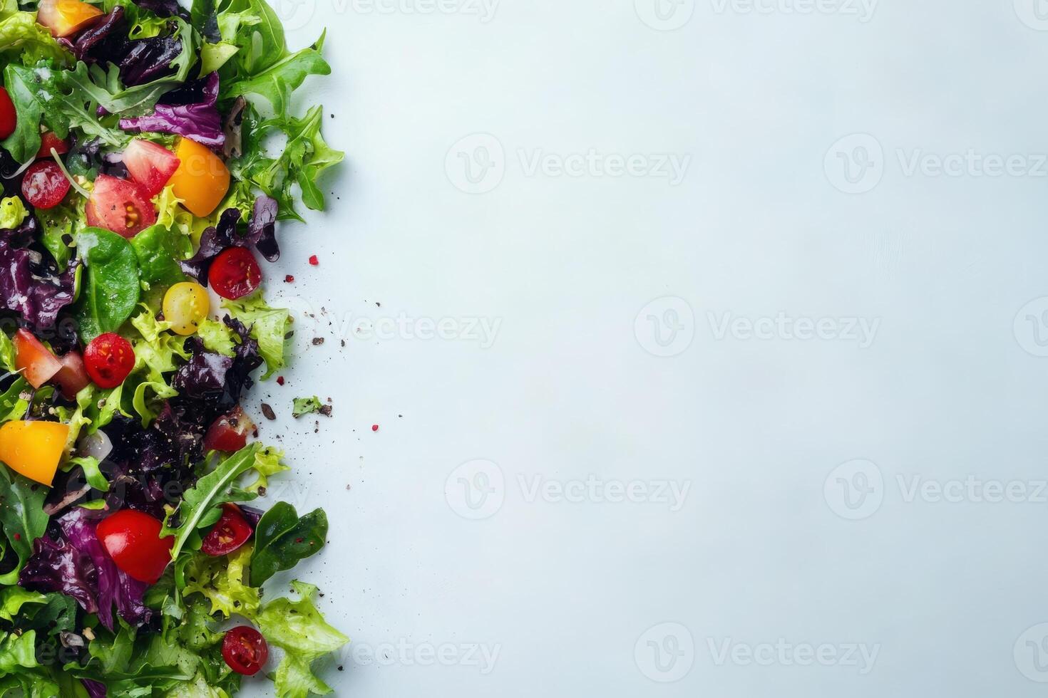 A vibrant mix of fresh salad ingredients showcases a variety of greens, tomatoes, and peppers, perfect for a healthy meal. photo