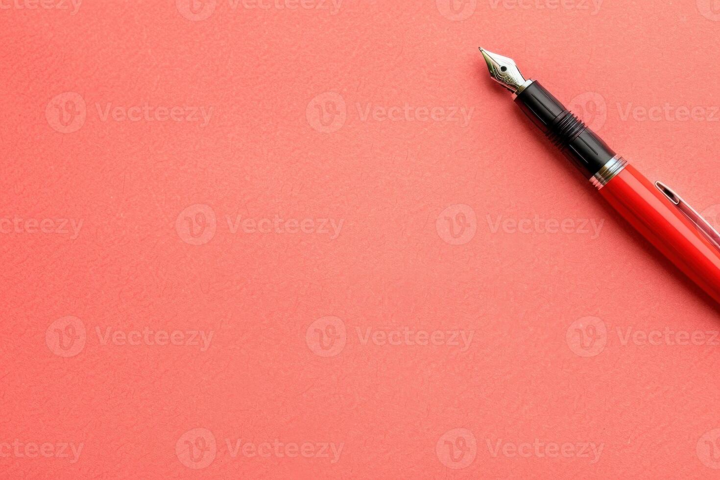 A sleek contact management list lies on a smooth coral surface, accompanied by a classic fountain pen poised for writing. photo