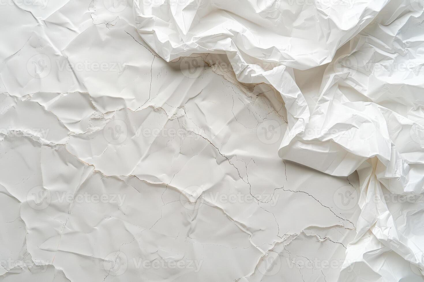 A wrinkled white sheet of paper spreads across a plain surface, showcasing unique textures and creases. photo