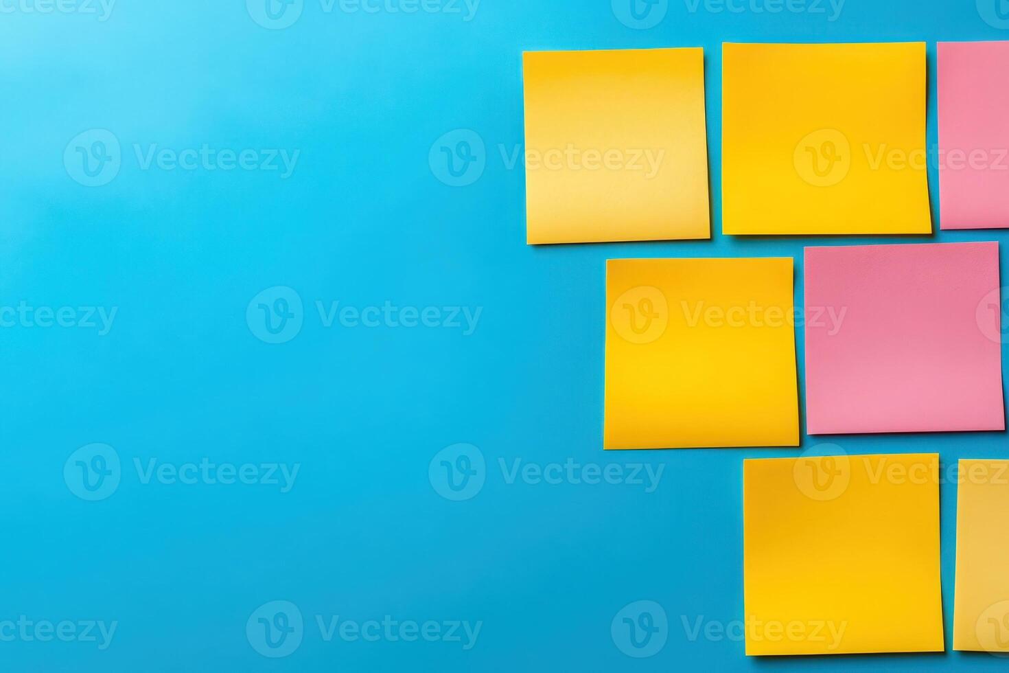A dynamic gathering of minds as colorful sticky notes are arranged on a bright blue surface during a brainstorming session. photo