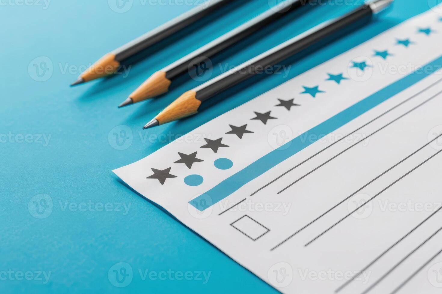 A neatly arranged feedback form lays on a bright blue surface, accompanied by sharpened pencils, inviting user input and reflections. photo