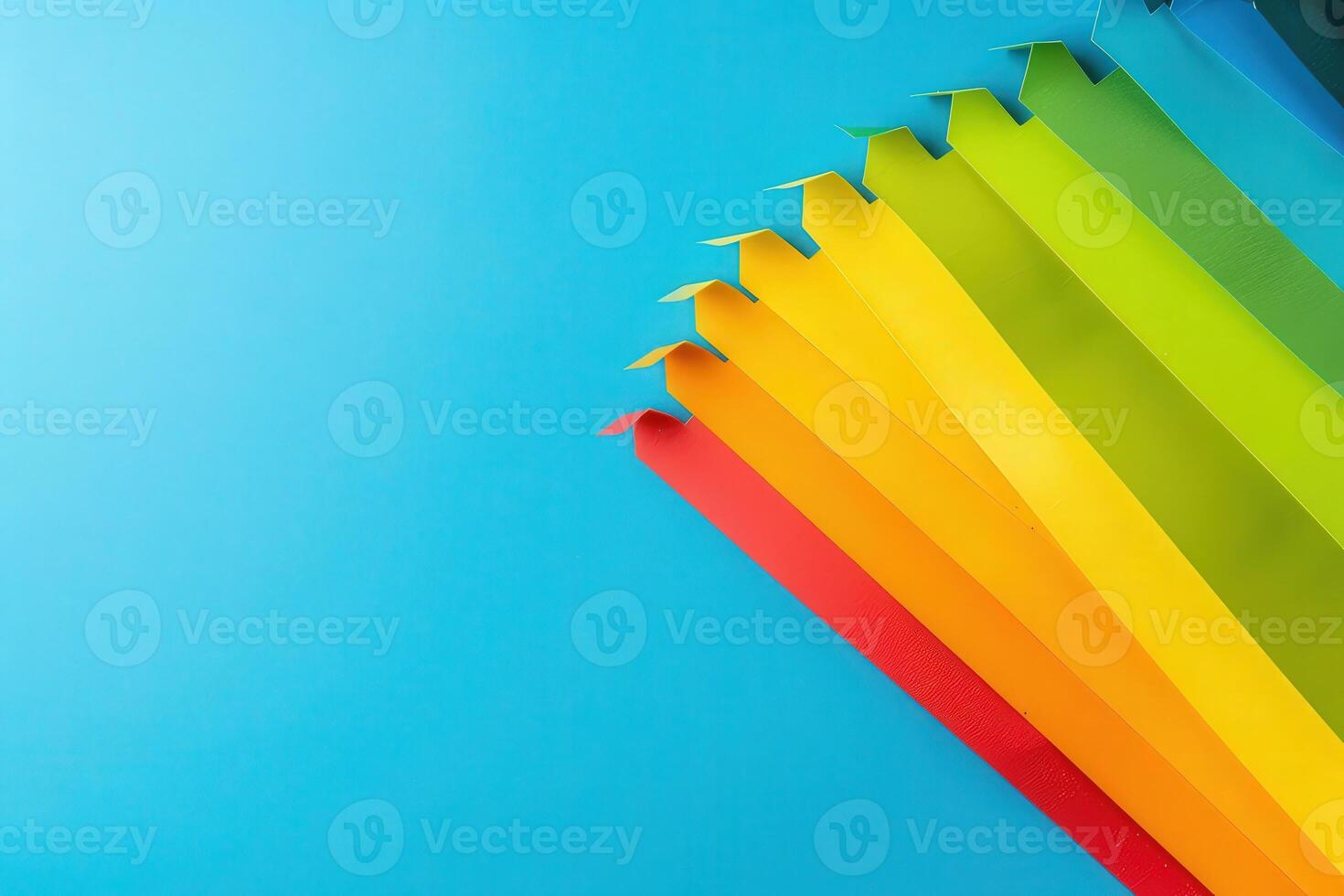 Colorful paper strips arranged in a gradient display energy efficiency ratings, creating a visually appealing representation against a smooth blue background. photo
