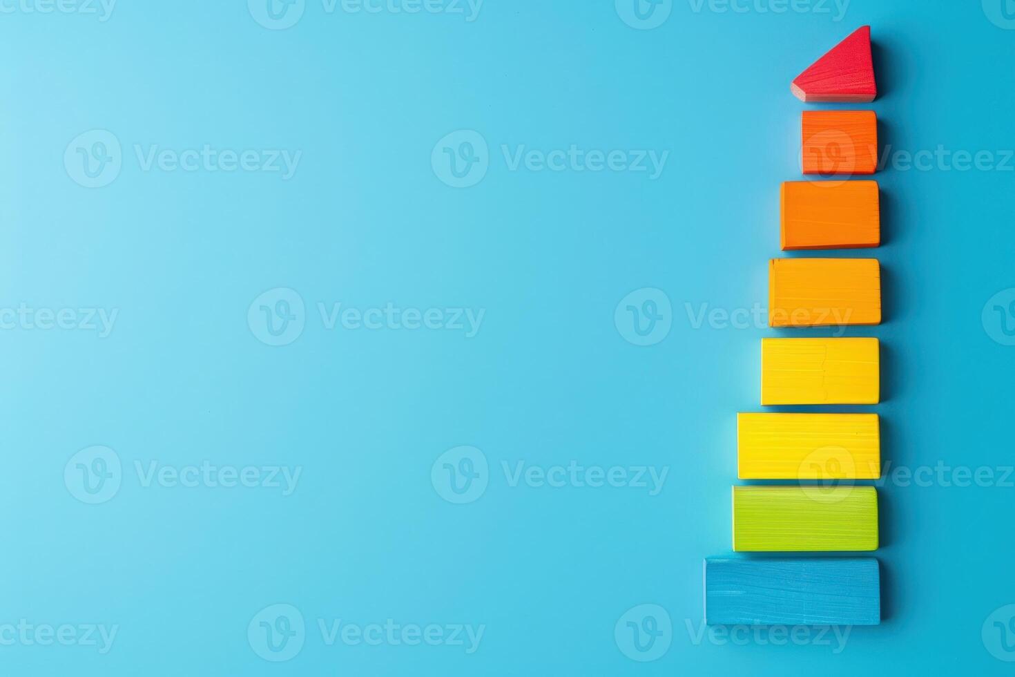 A vibrant arrangement of colorful blocks indicating energy efficiency levels, transitioning from red to blue against a serene blue background. photo